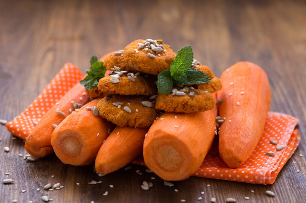 Homemade carrot cookie on a dark wooden background. Healthy food for vegans