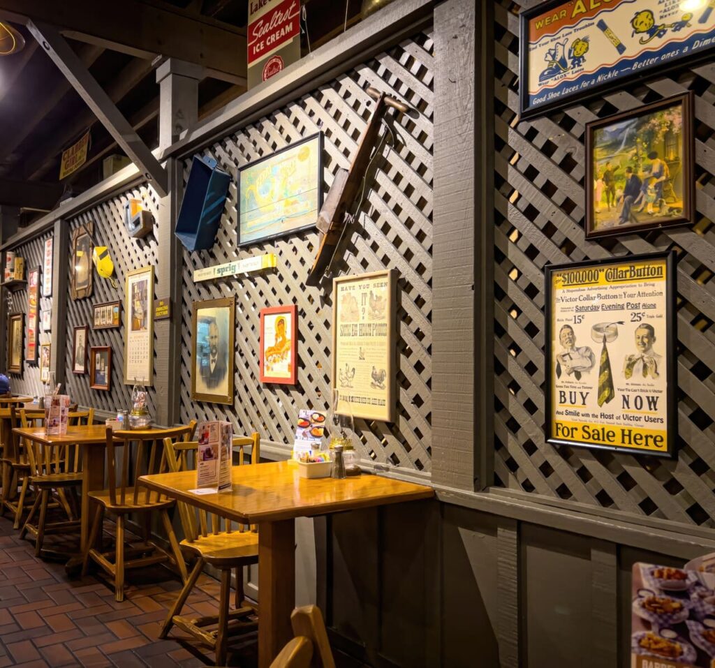 Interior dining area showing rustic décor, wooden tables, and lamps.