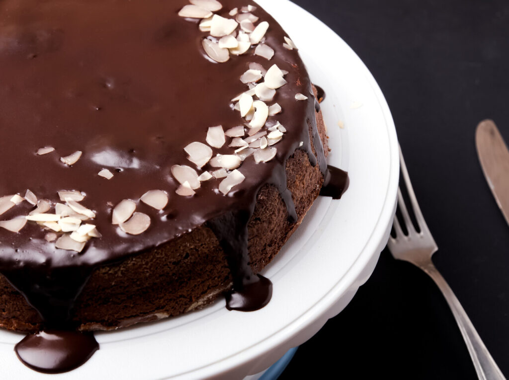 Chocolate cake with chocolate frosting on black background
