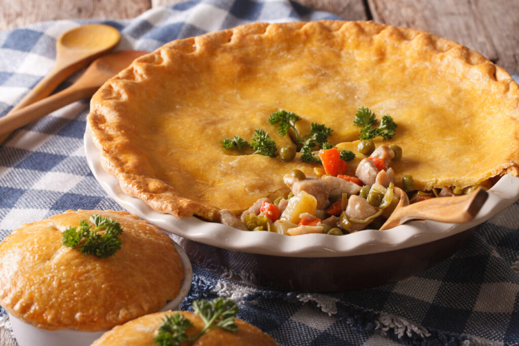 American food: Chicken pot pie close-up in baking dish on the table.
