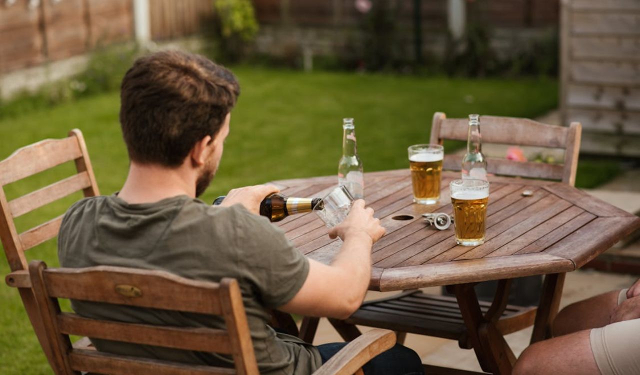 Friends drinking beer and pouring beer in glass