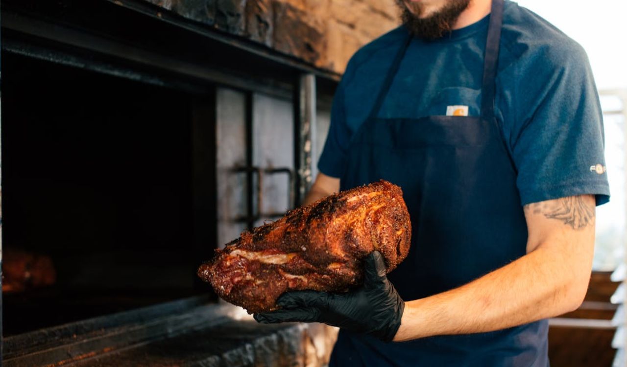 Man holding roasted meat