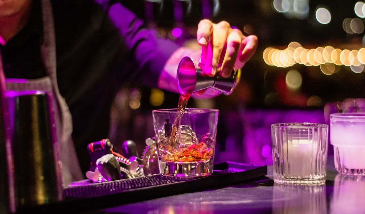 Pouring liquor in clear drinking glass
