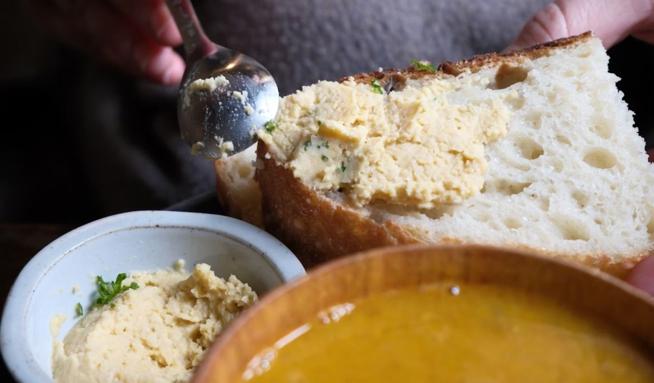 Spreading garlic on bread