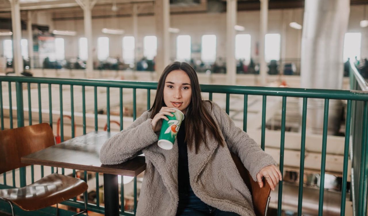 Woman drinking from a soda cup