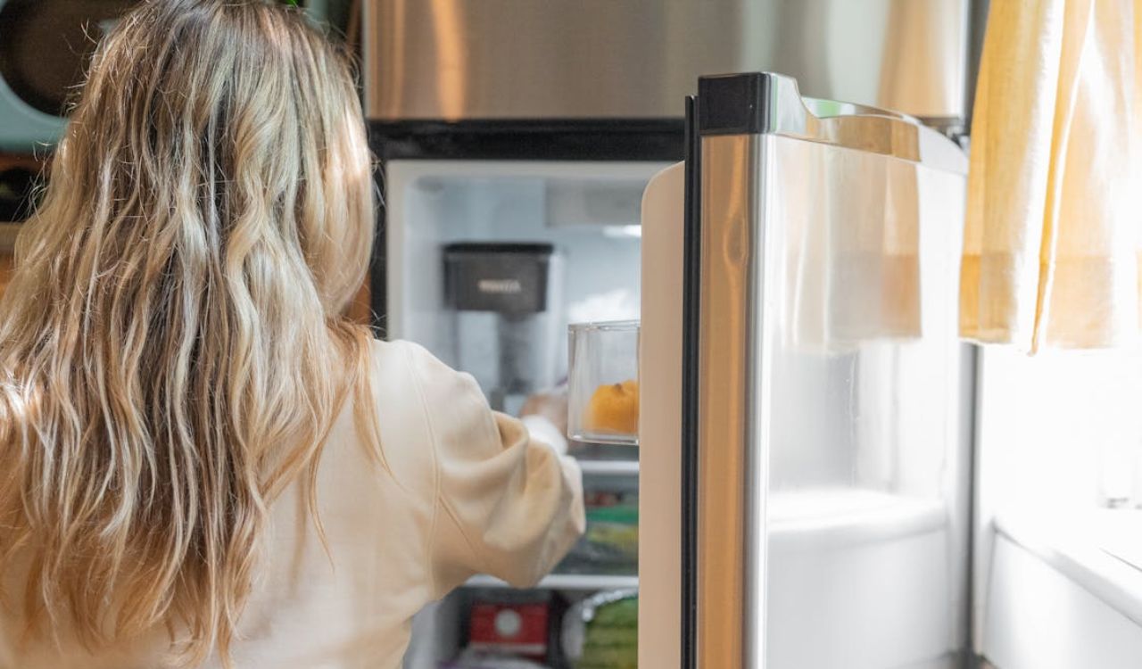 Woman in front of refrigerator