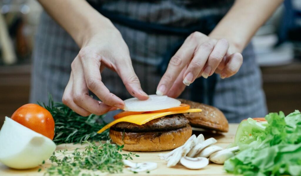 Woman preparing a burger