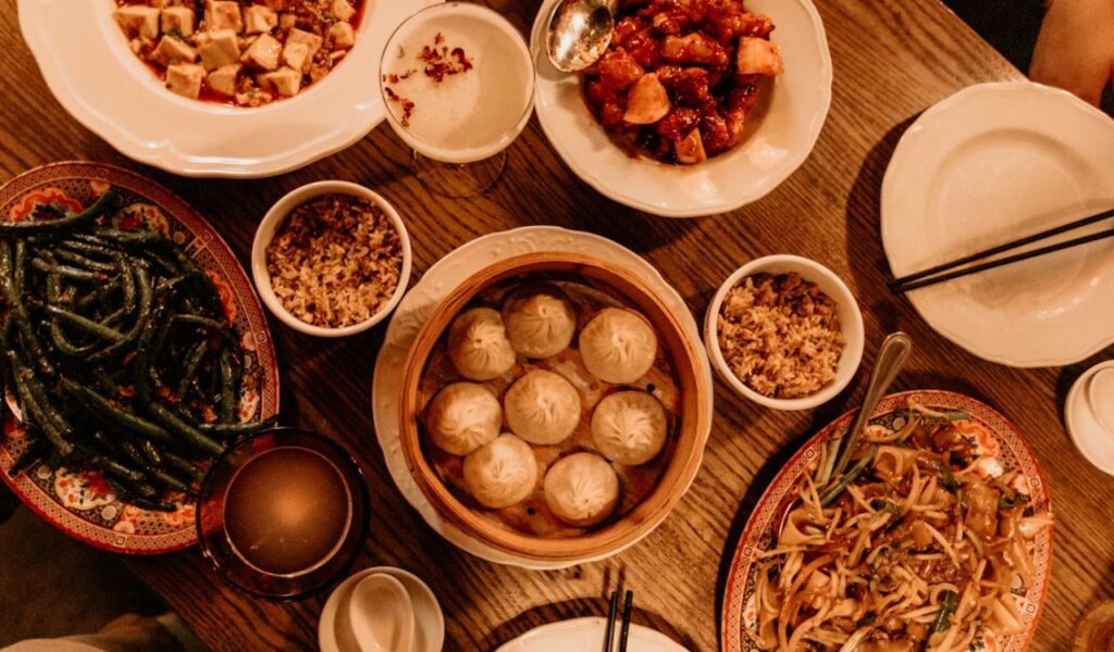 Wooden table with Chinese food