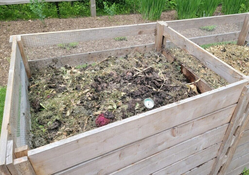 Hands tossing banana peels into a home compost bin or community compost station.