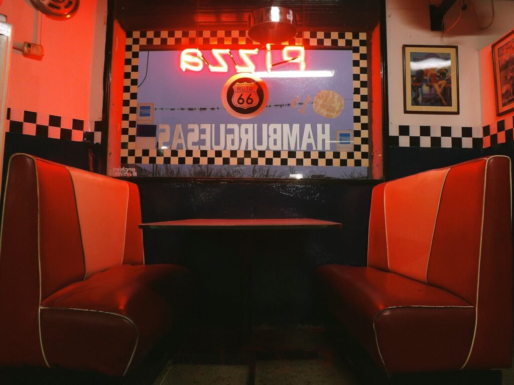 mom-and-pop restaurant exterior, cozy booth seating, vintage restaurant signage.