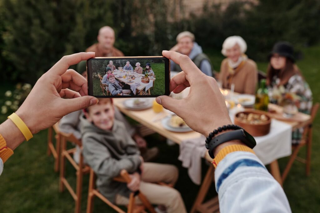 Family enjoying a meal together while filling out a quick digital survey or leaving feedback on a tablet.