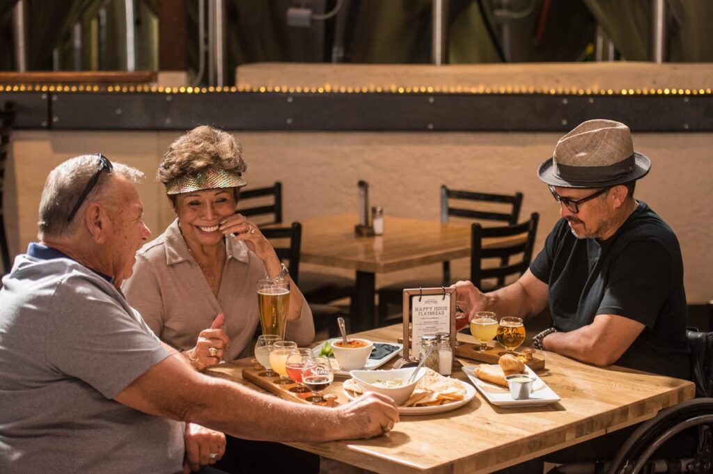 vintage dining table conversation, couple laughing over dinner, empty restaurant table without phones.