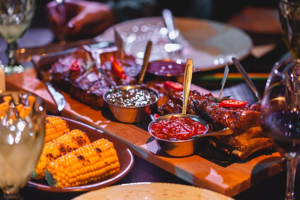 A platter of gochujang-glazed ribs and chipotle-brushed brisket tacos