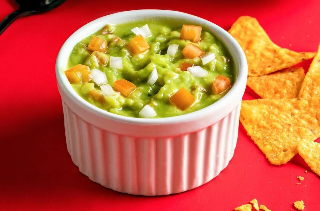 avocado chunks mixed with peppers, tomatoes, and onion in a guacamole-style salad.