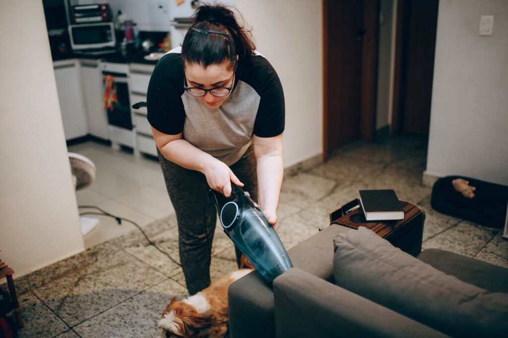 A person vacuuming a living room