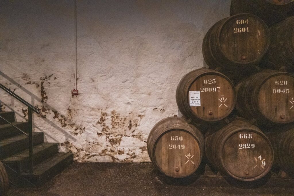 Whisky casks labeled “Sherry,” “Port,” or “Rum” in a cellar.