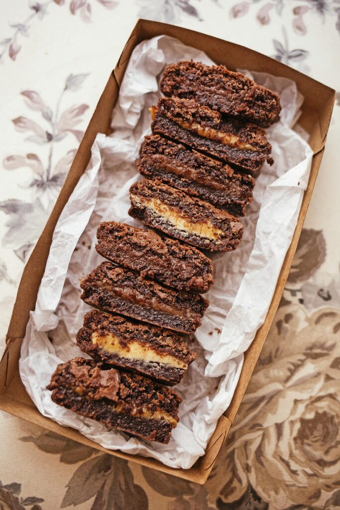 A tray of homemade brownies next to store-bought packaging