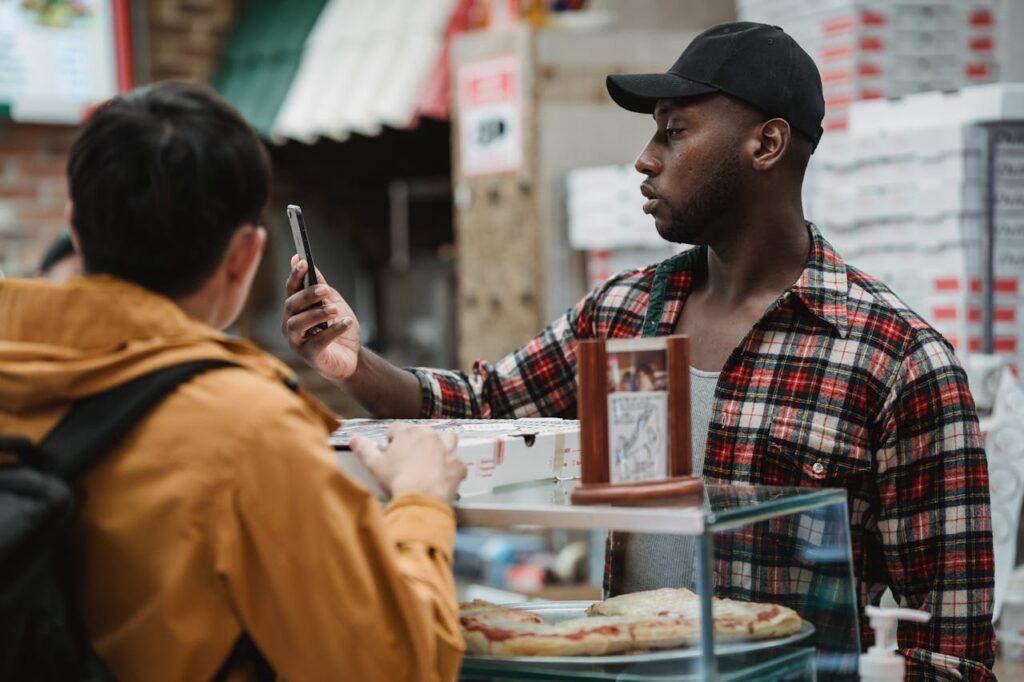 Customer looking at custom fast food menu order on phone.
