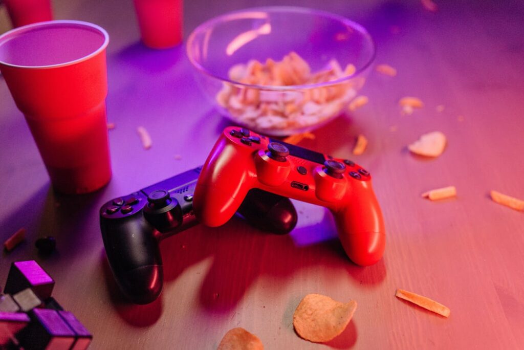 Close-Up Shot of Game Controllers with snacks