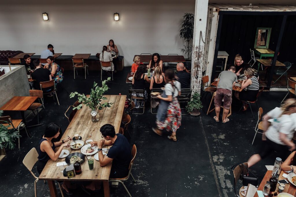 vintage fine dining table, small plated meal, people conversing between courses.