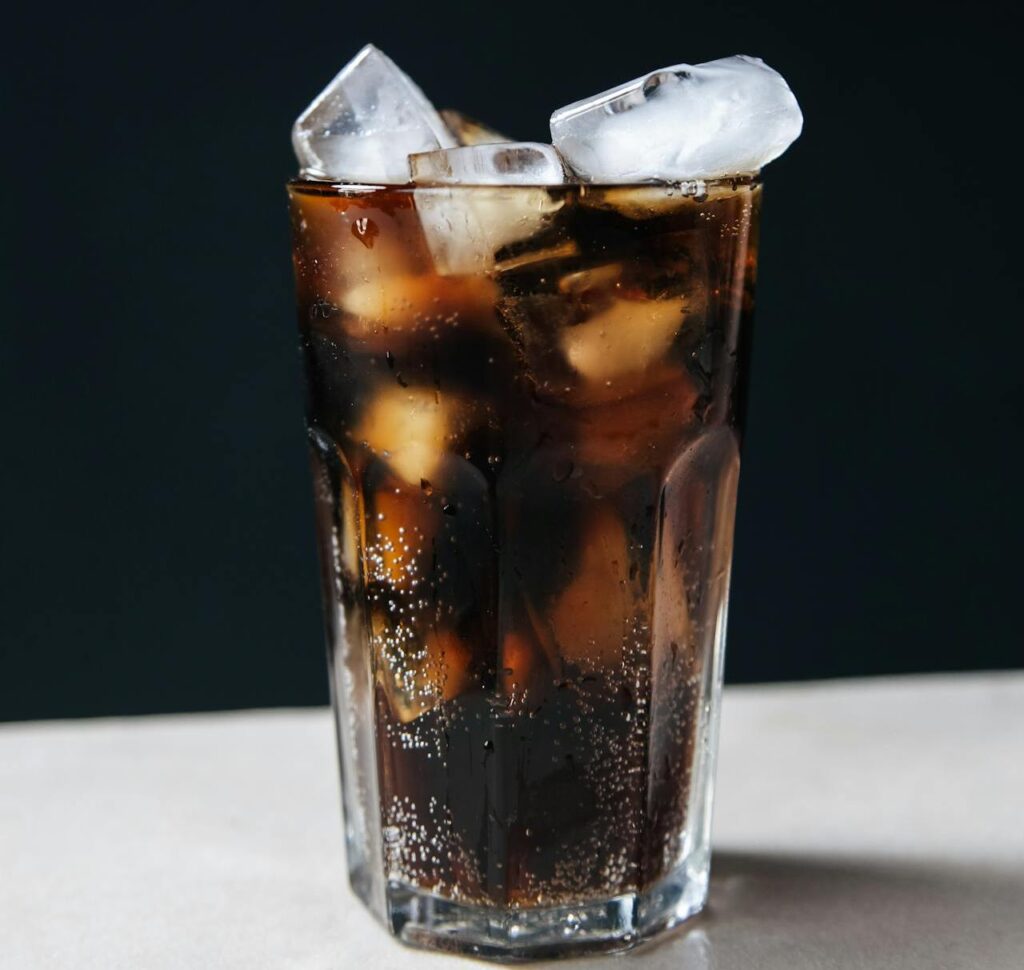 A fast-food soda cup filled mostly with ice