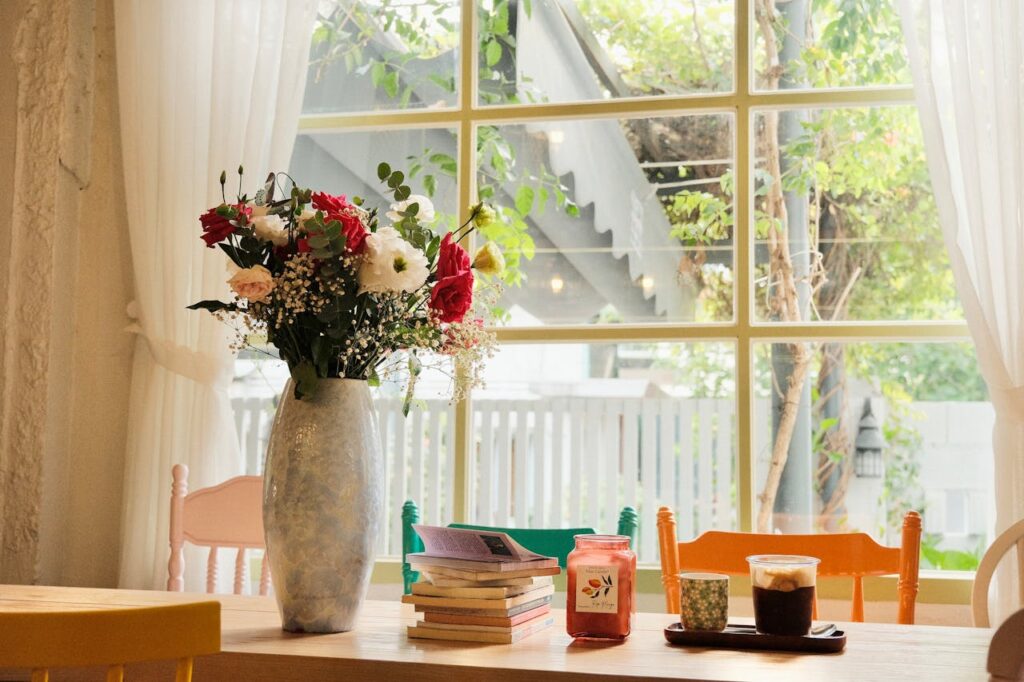 Open windows with light curtains blowing gently in fresh air.