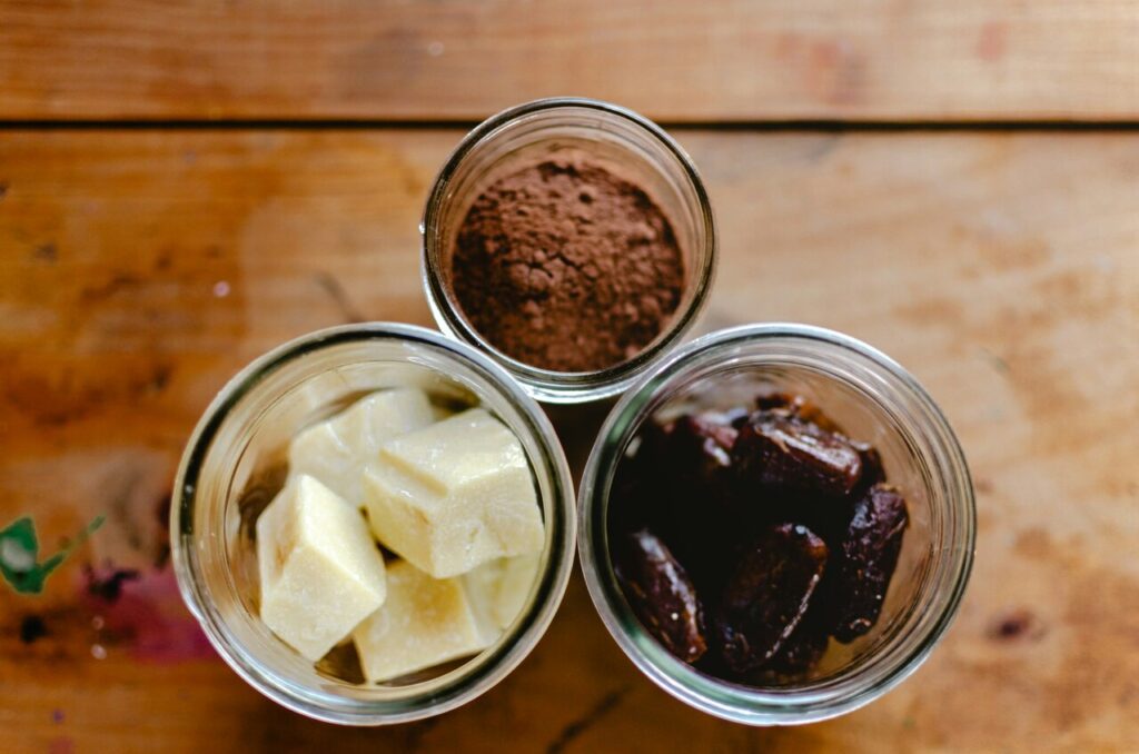 Close-up of cocoa, chocolate chips, and butter.