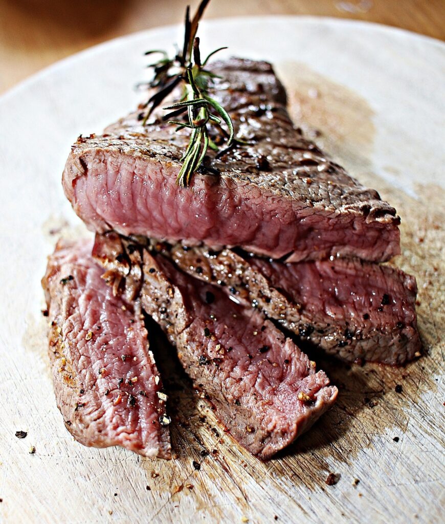 Cross-section of a steak showing even pink doneness.