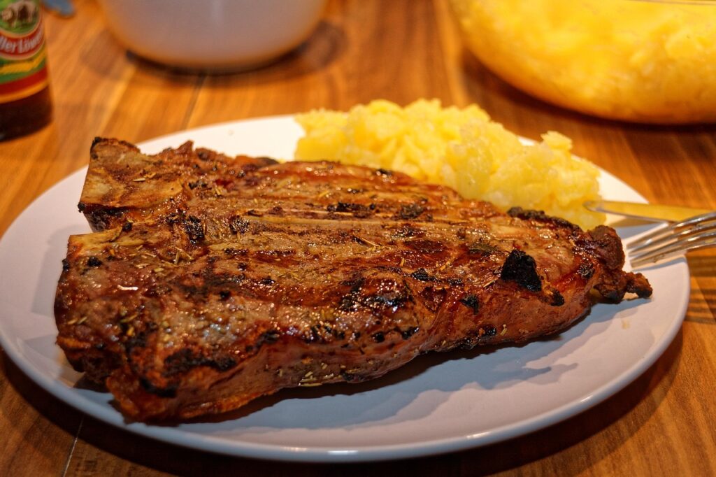 An oversized steak covering an entire plate.