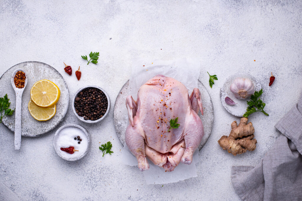 Raw chicken with different herbs and spices