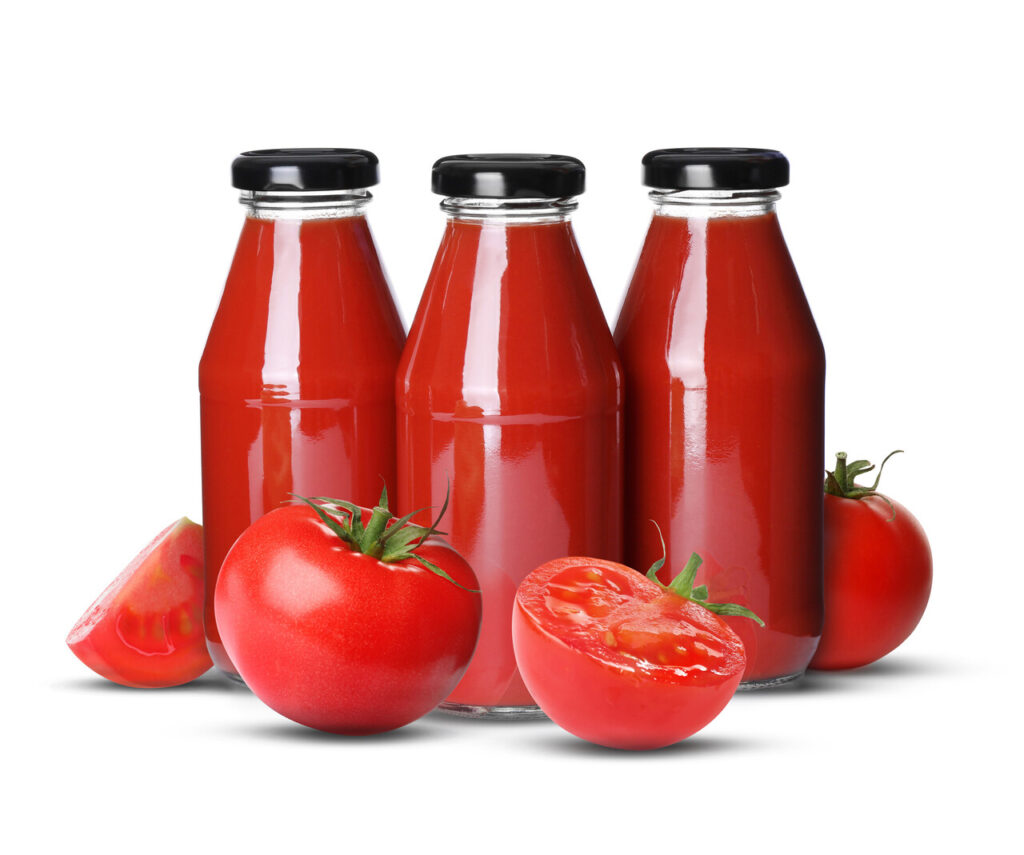 Bottles with tomato juice isolated on white