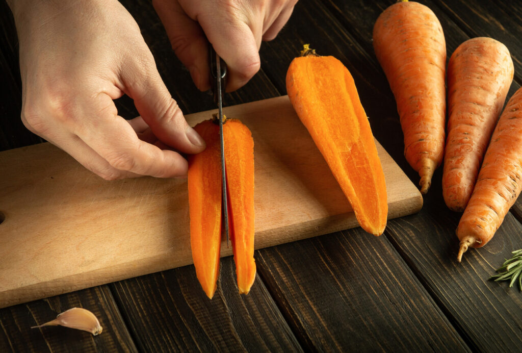 Person Slicing a Carrot