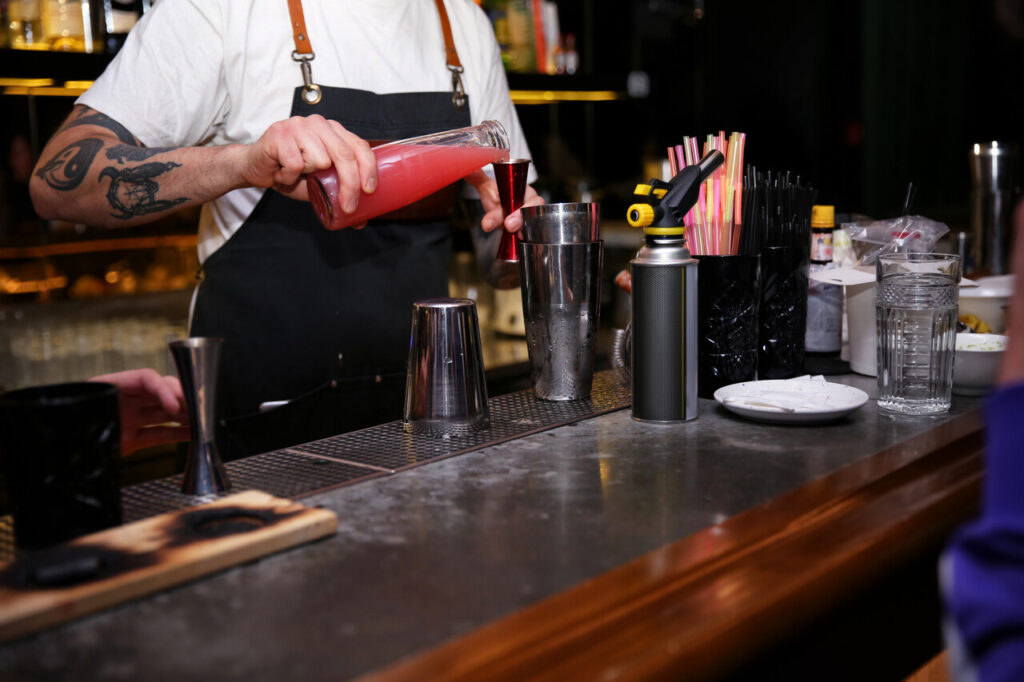 A modern craft cocktail bar with precision tools and elegant plating