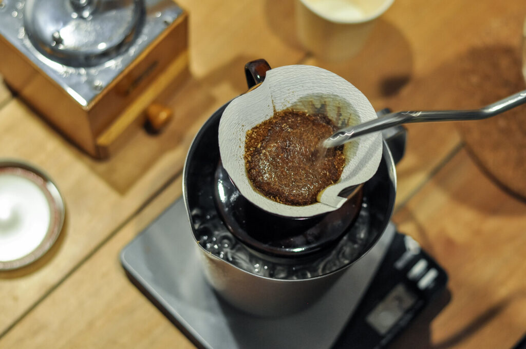 Coffee being brewed with mushroom powder on the side.