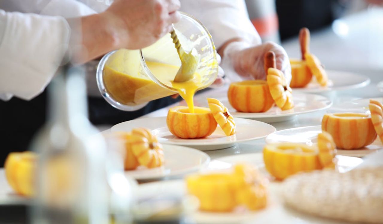 Chef pouring pumpkin soup