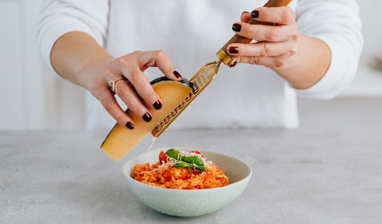 Grating cheese on top of risotto