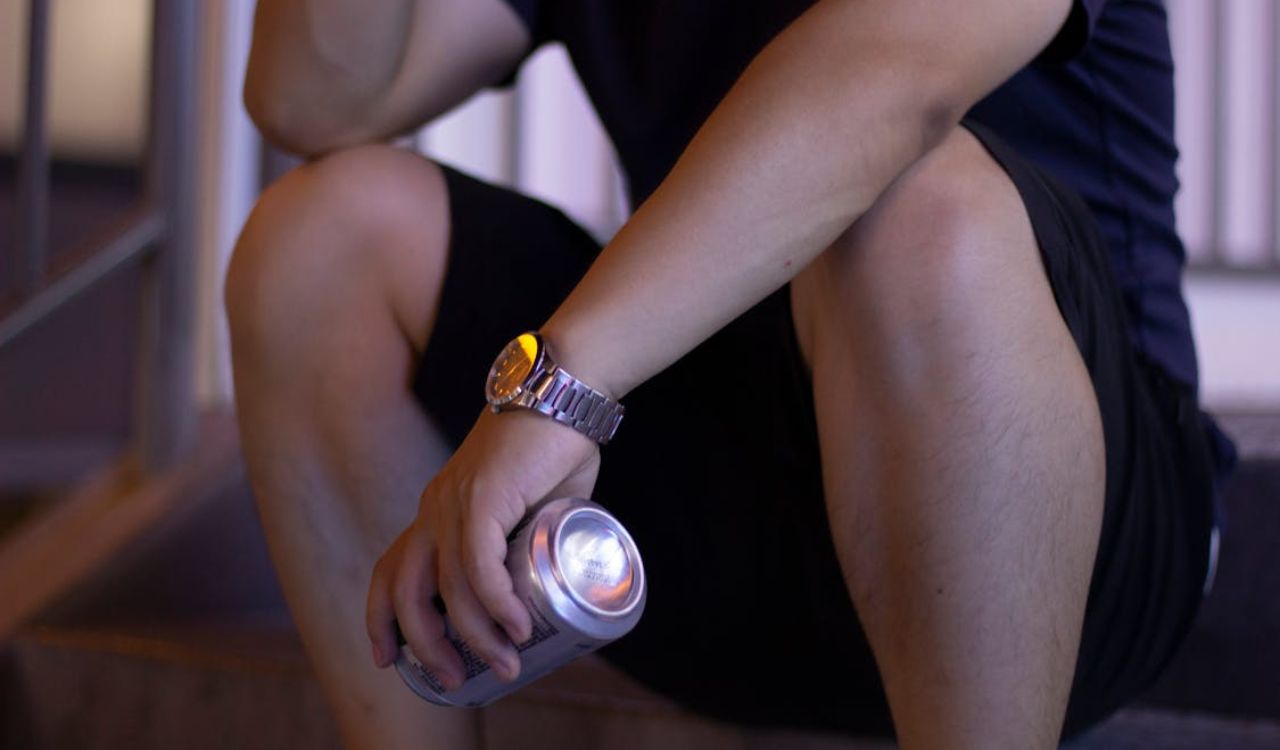 Man holding a canned drink