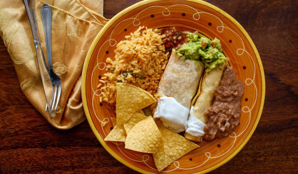 Mexican burrito and taquito dinner with rice and refried pinto beans