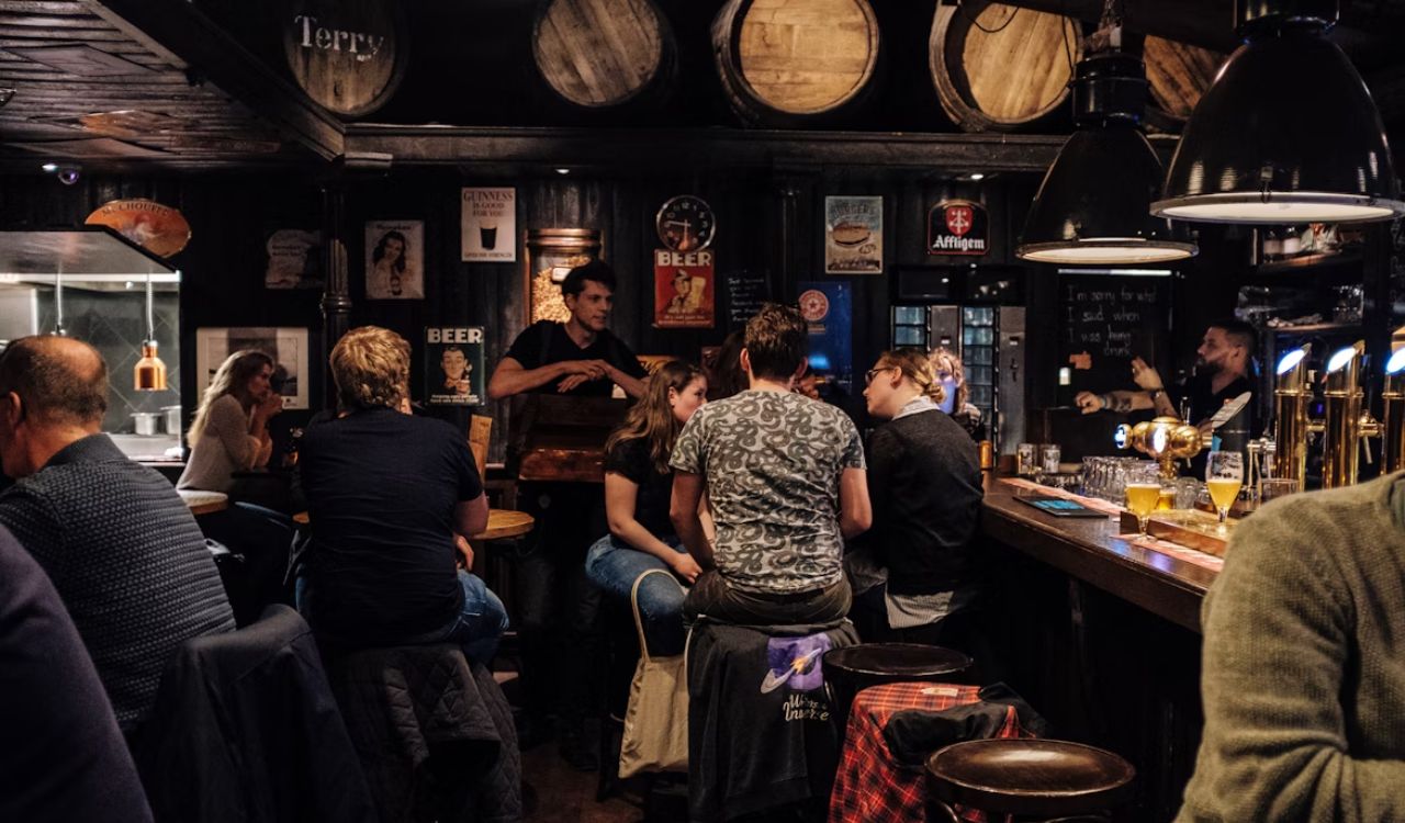 People chatting and drinking in a dive bar