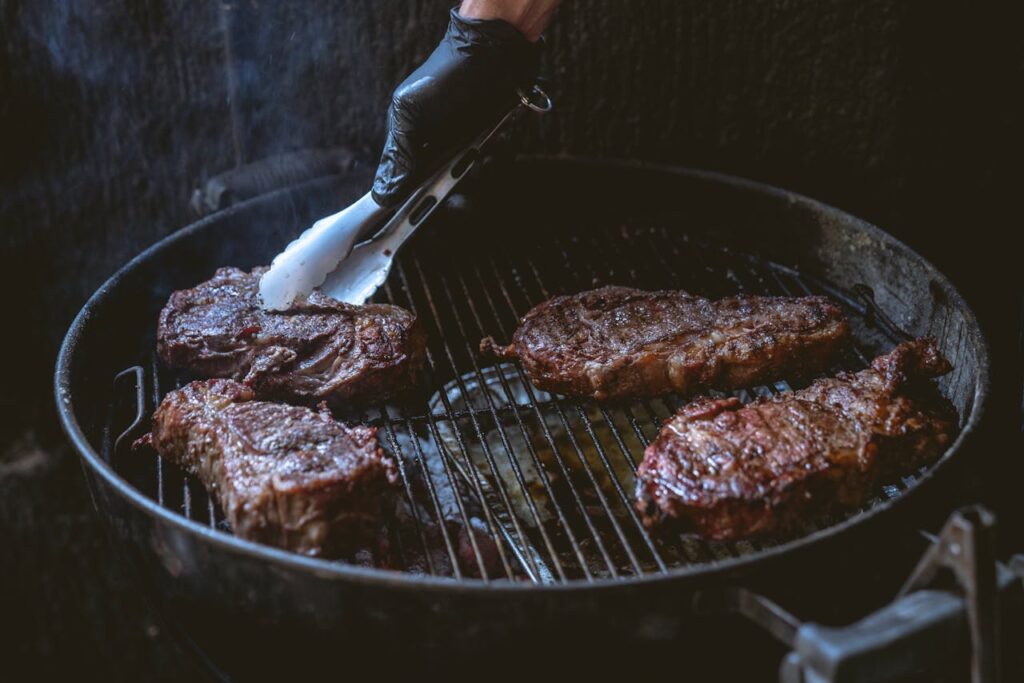 Steak on a wire rack in the oven before searing.