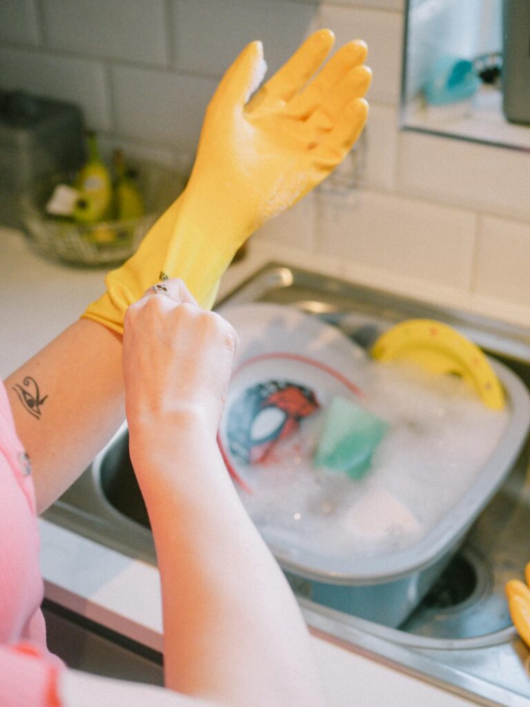 A kitchen counter with a classic washing-up bowl filled with hot soapy water