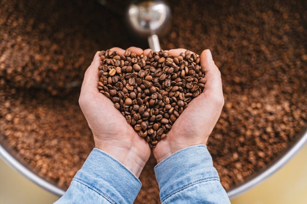 Hand-cranked coffee grinder and roasted beans.