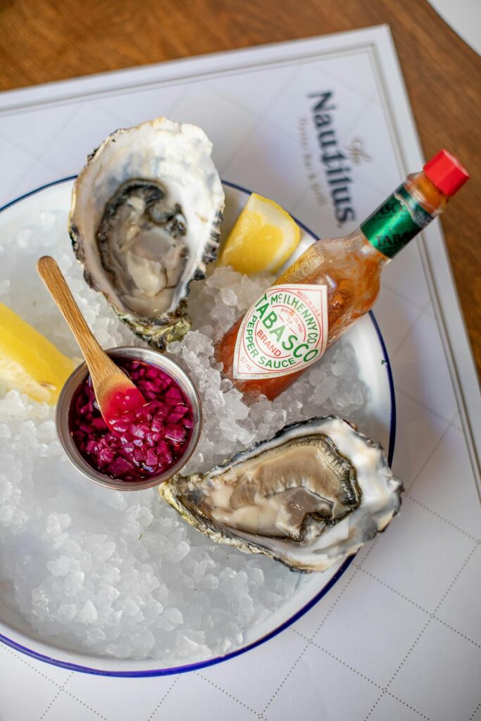 A row of sour beers or gose with oysters topped with mignonette.