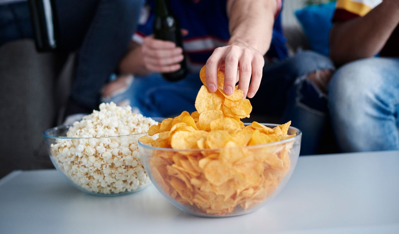 Close up of mens hand grabbing chips
