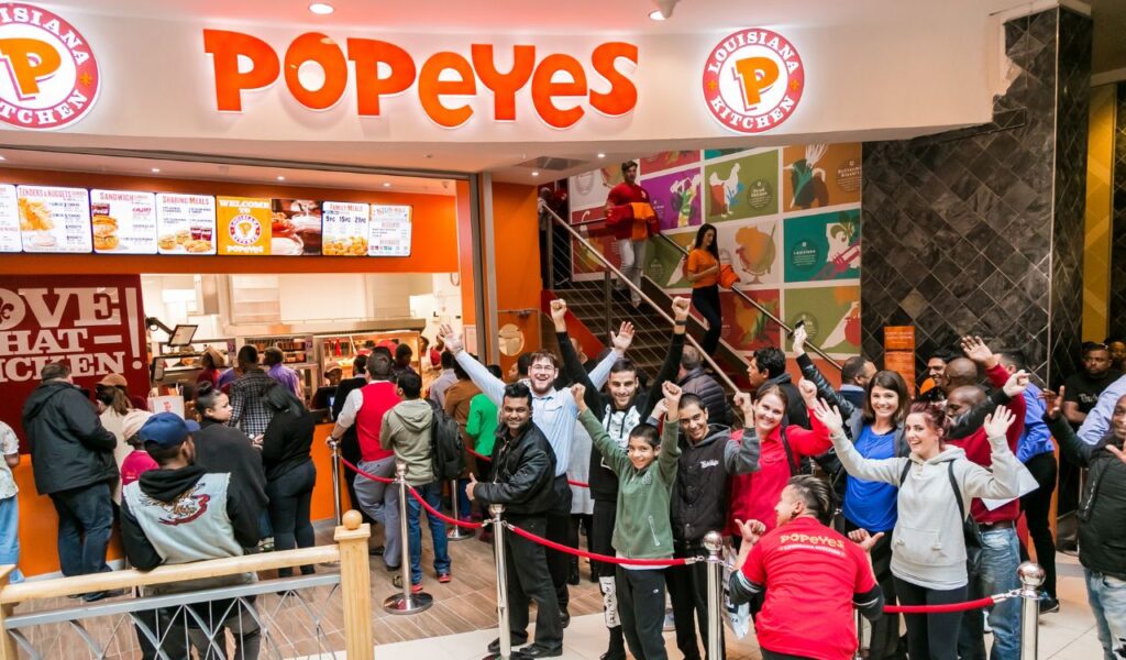 Customers at a Popeyes Take Out Fast Food Restaurant