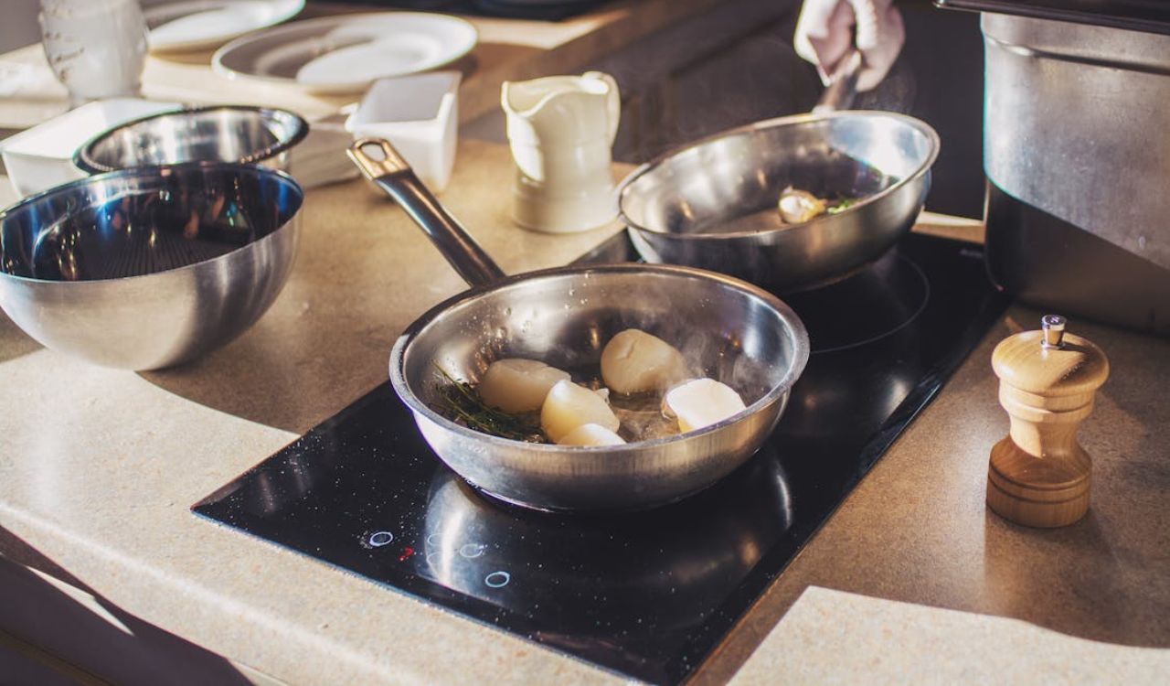 Stainless pans on top of glass stove